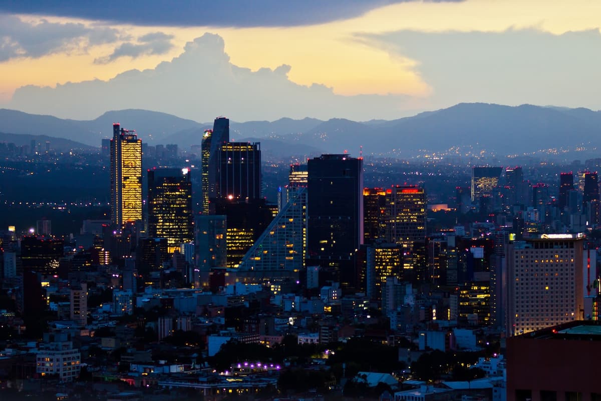 Vista aérea de Monterrey al atardecer, con edificios y montañas, simbolizando los servicios de Bioclimex en áreas metropolitanas y al aire libre.